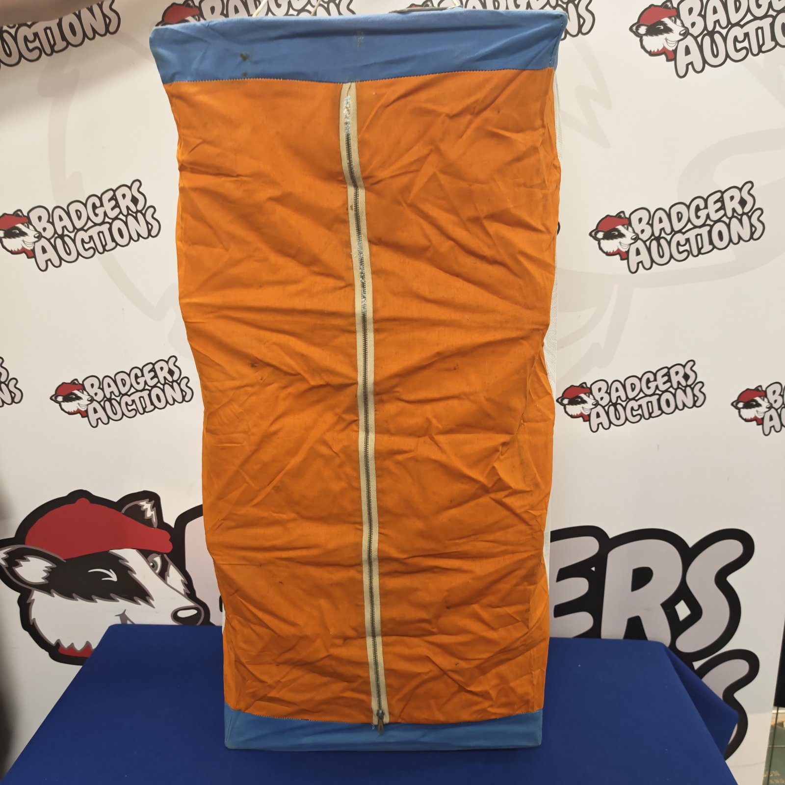 Vintage orange and blue camping pantry for outdoor storage.