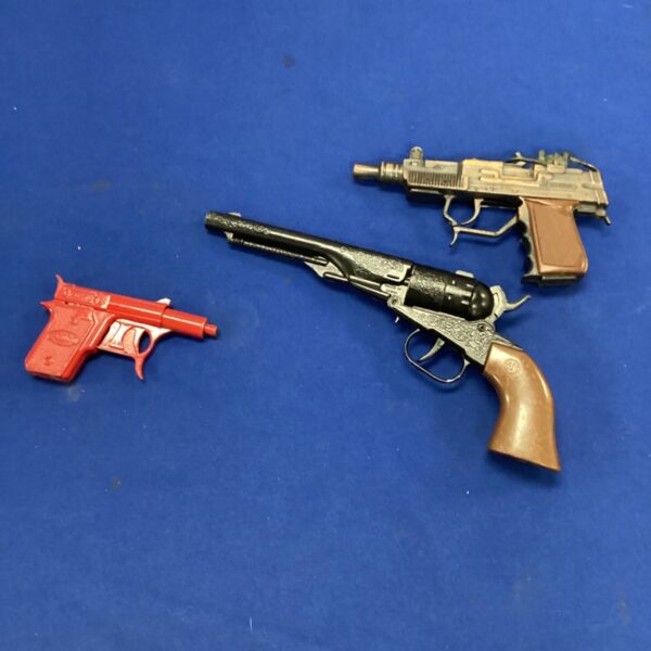 Vintage cap guns and Spudmatic spud gun set for collectors.