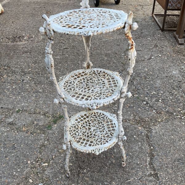 Ornate vintage cast iron plant stand with three tiers.