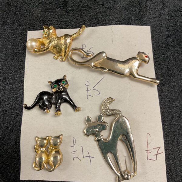Group of five vintage cat brooches in gold tone.