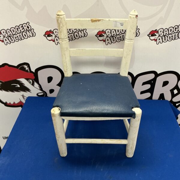 Vintage child’s chair with a blue leather seat, collectible furniture.