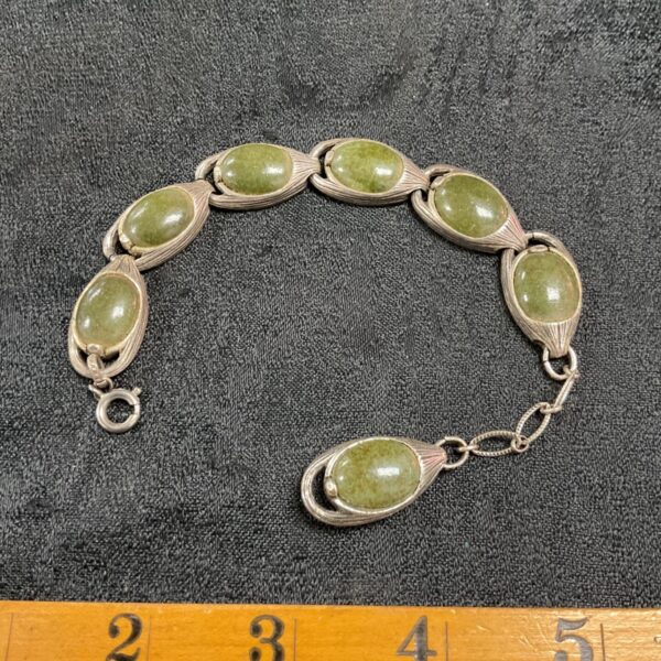 Vintage Chinese export bracelet with green jade cabochons and silver tone.