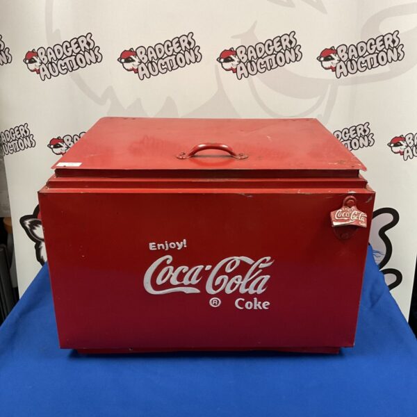 Red vintage Coca-Cola cooler with white logo.