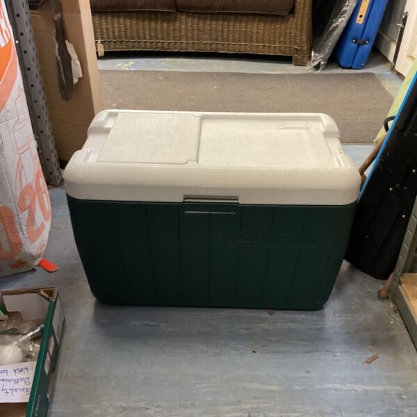 Vintage green Coleman Kwikserv cooler for camping and picnics.
