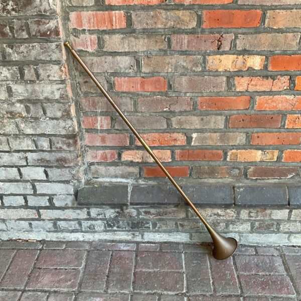 Vintage copper and brass hunting horn, antique musical instrument.