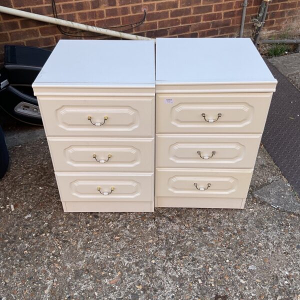 Vintage cream bedside cabinet with brass handles for bedroom storage.