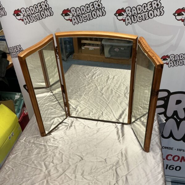 Vintage dresser mirror with wooden frame, ideal for bedroom vanity.