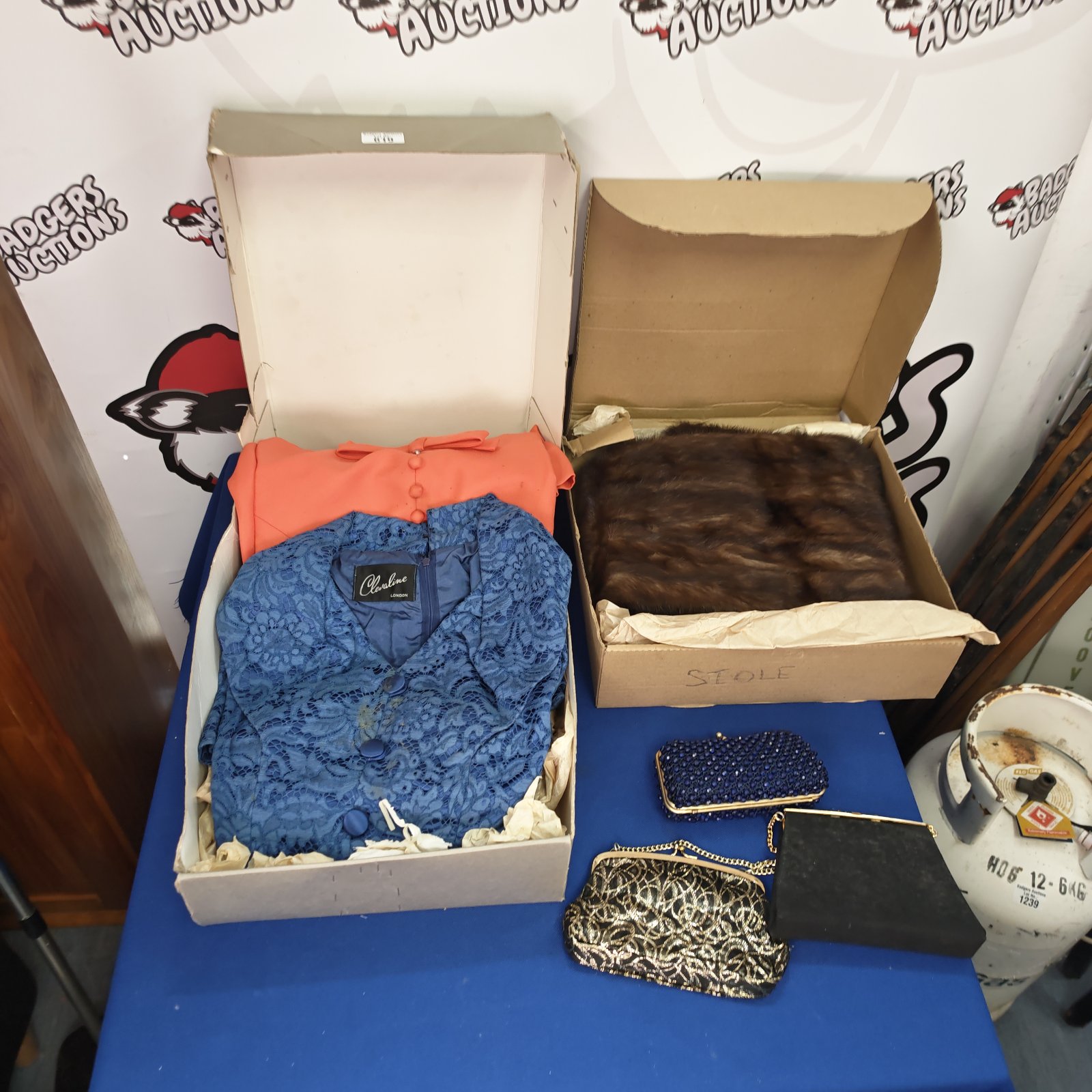 Vintage dresses, faux fur stole, and purses lot for collectors.