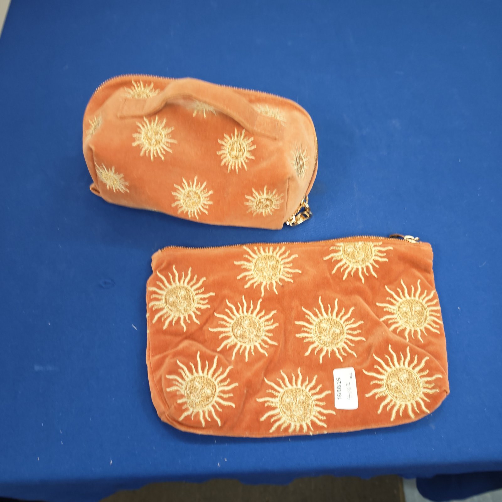 Vintage Elizabeth scarlet makeup bag with golden sunburst embroidery.