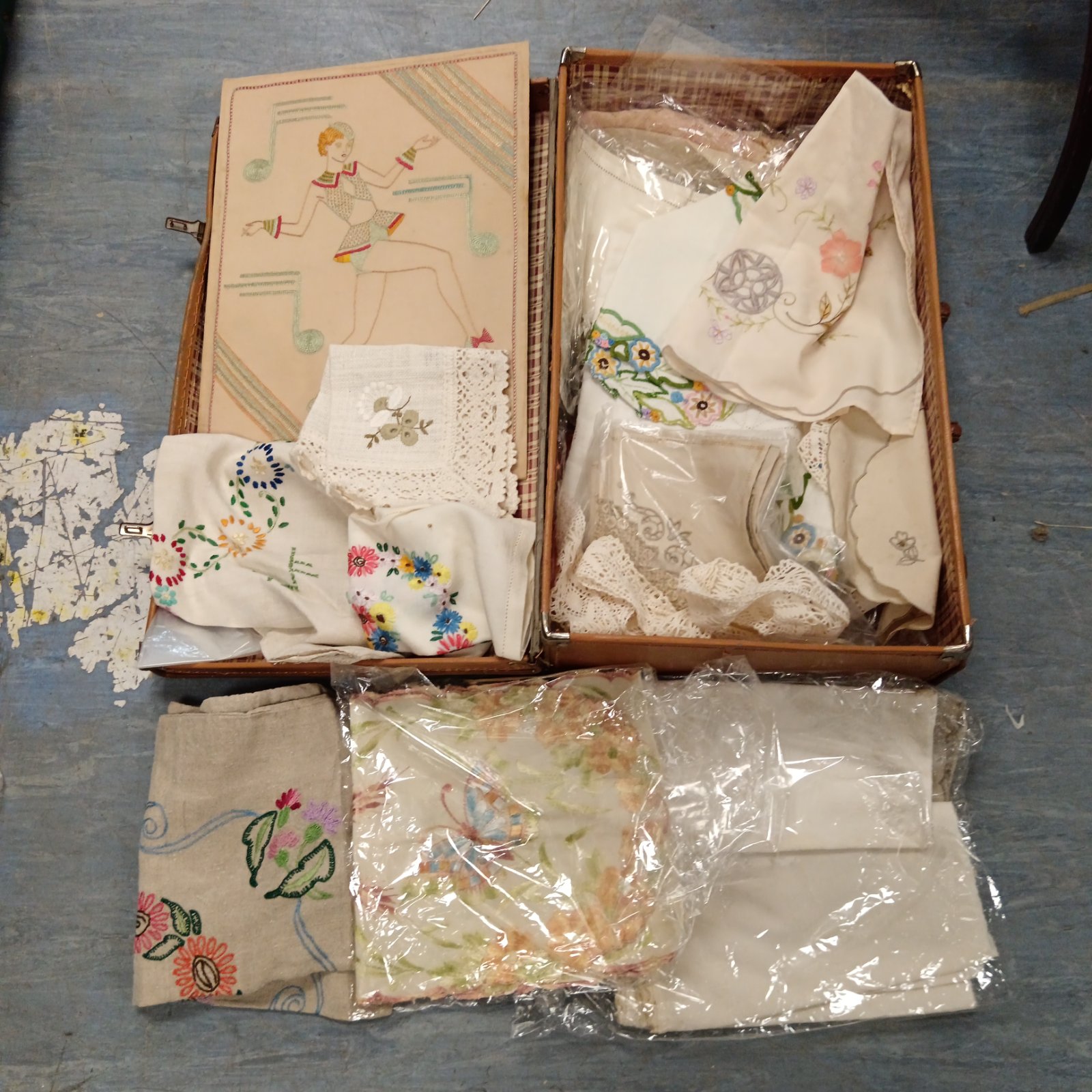 Vintage embroidery and lacework collection in a woven case.