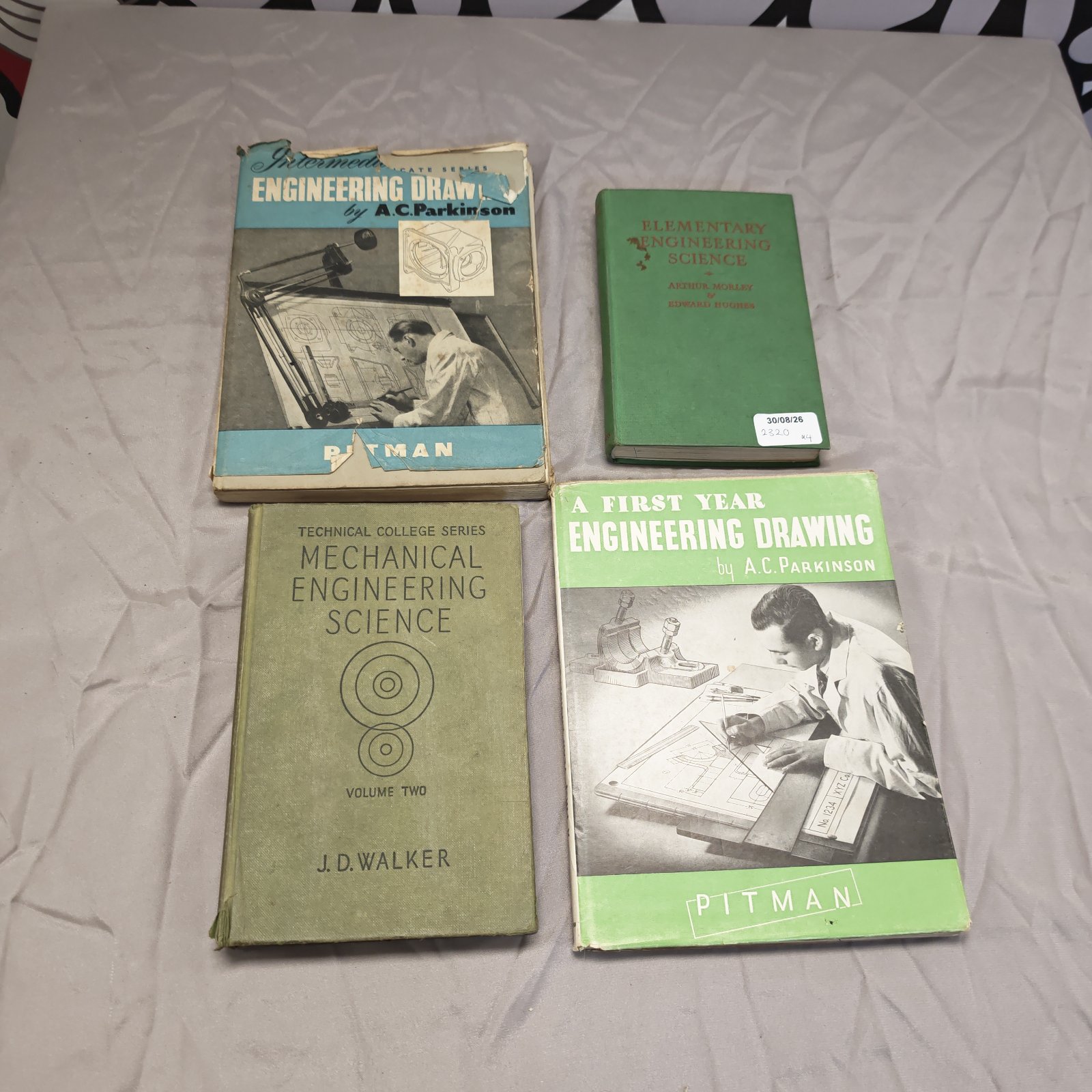 Vintage engineering books including drawing and science textbooks.
