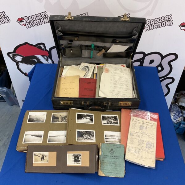 Vintage ephemera collection in a leather suitcase, featuring RAF documents and photos.