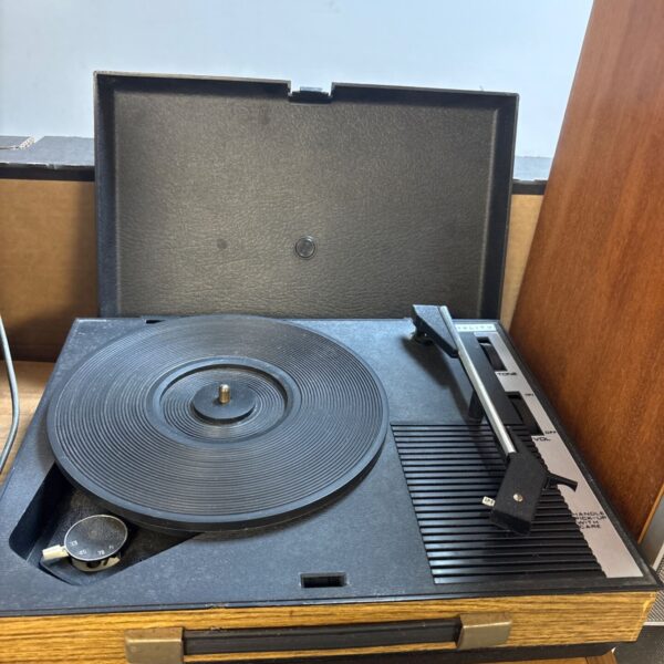 Vintage Fidelity record player on a wooden surface.