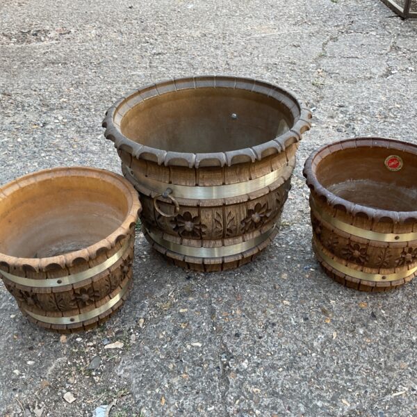 Vintage brown floral planter with decorative metal bands.