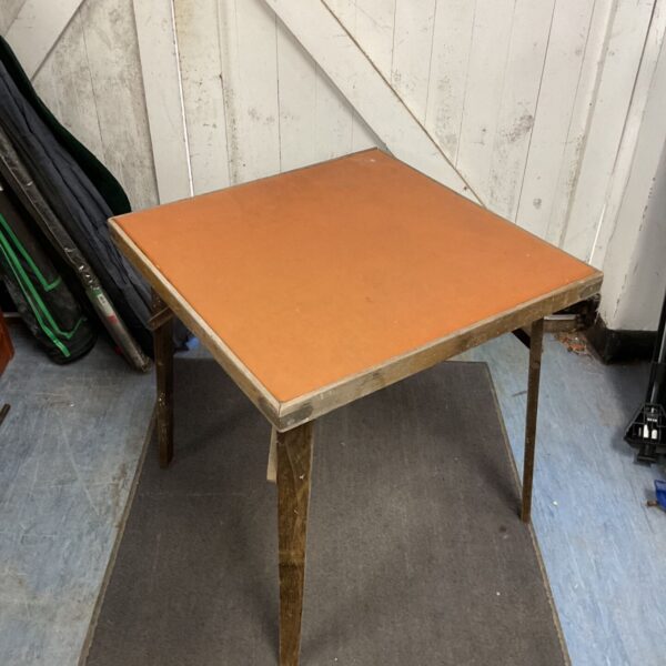 Vintage folding card table with leather top, ideal for game nights.