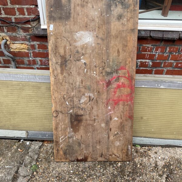 Vintage folding wooden table with weathered surface and rustic appeal.