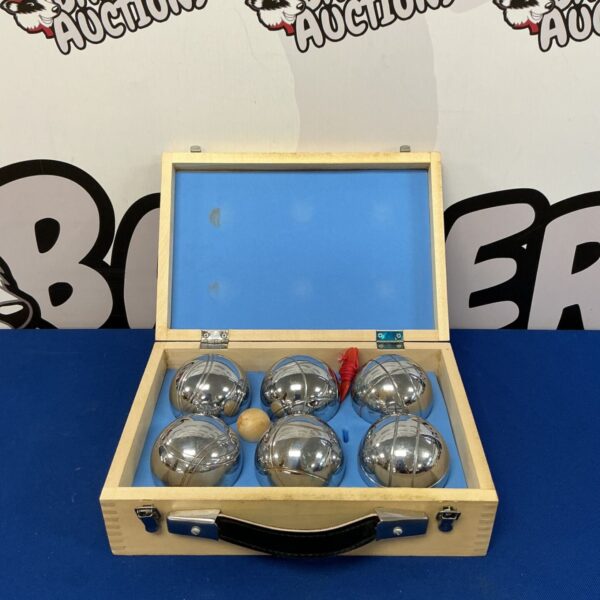 Vintage French boule set in wooden case for outdoor games.
