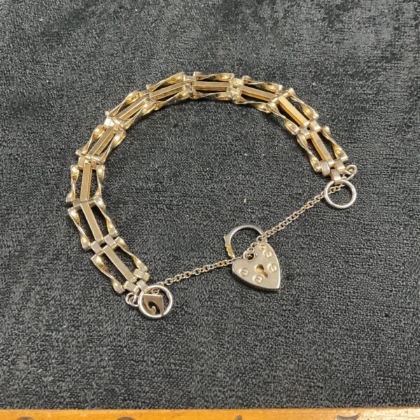 Vintage gold-tone gate bracelet with heart clasp.