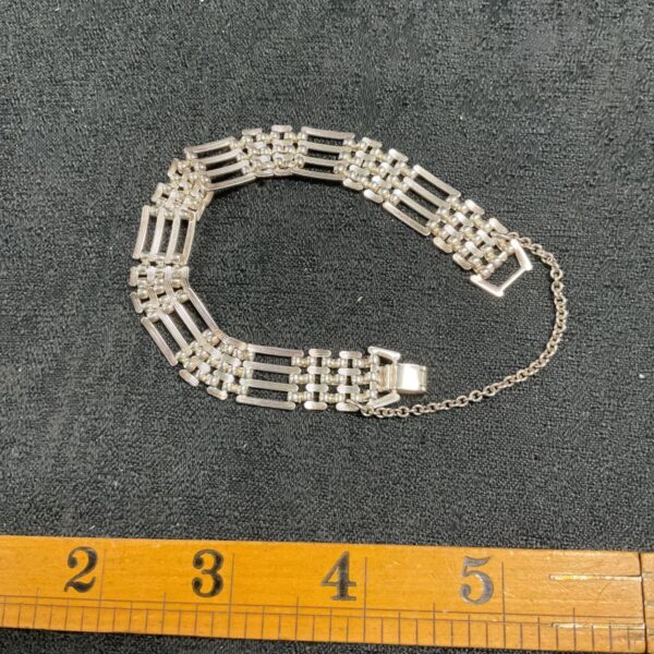 Vintage silver gate bracelet with interlocking links and clasp.