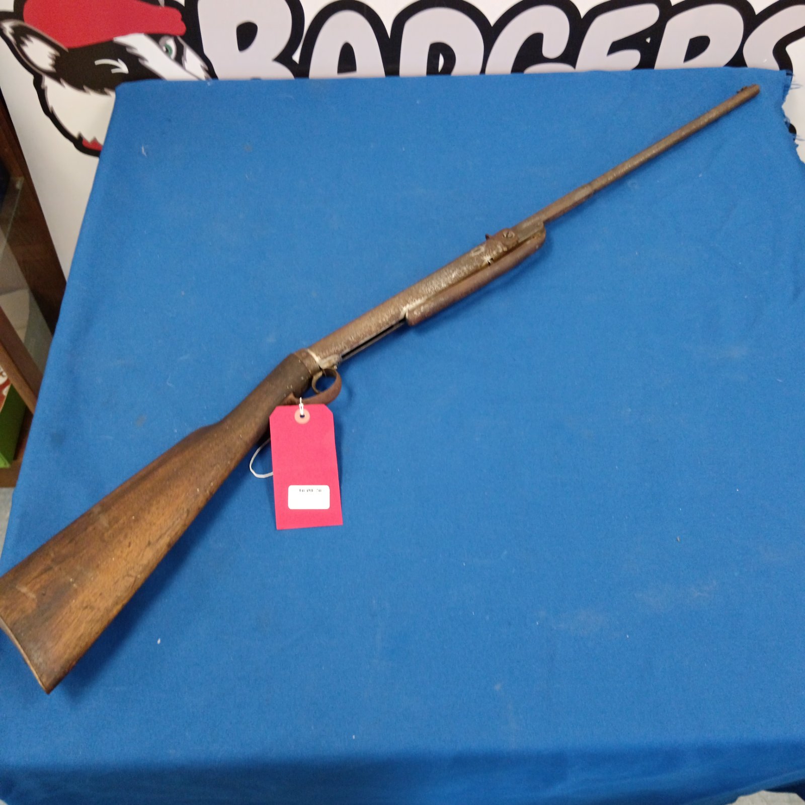Vintage German air gun with wooden stock and metal barrel.