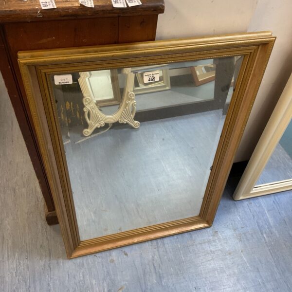 Ornate vintage wall mirror with a gilded frame.