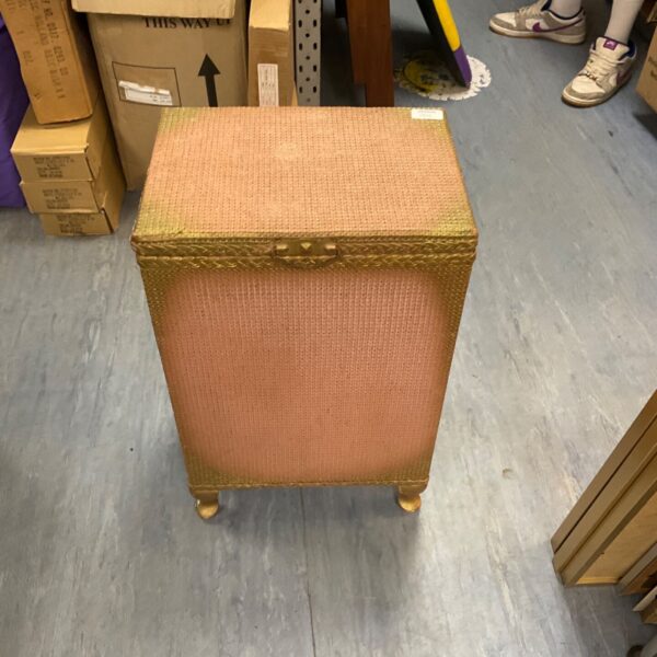 Vintage gold Lloyd Loom laundry basket, a classic woven hamper.