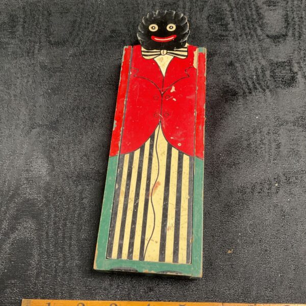 Vintage golly pencil case with colourful character design.