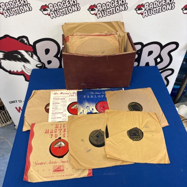 Vintage gramophone records including His Master's Voice records in a collection.