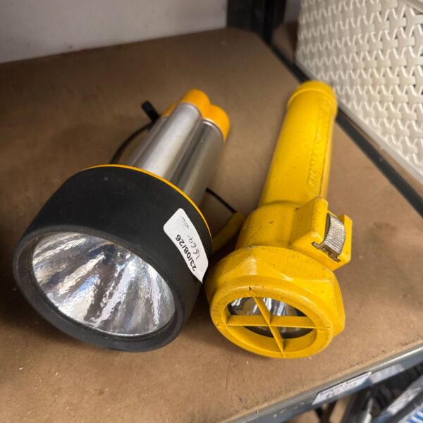 Vintage Ikelite underwater torch with yellow housing and metal bezel.