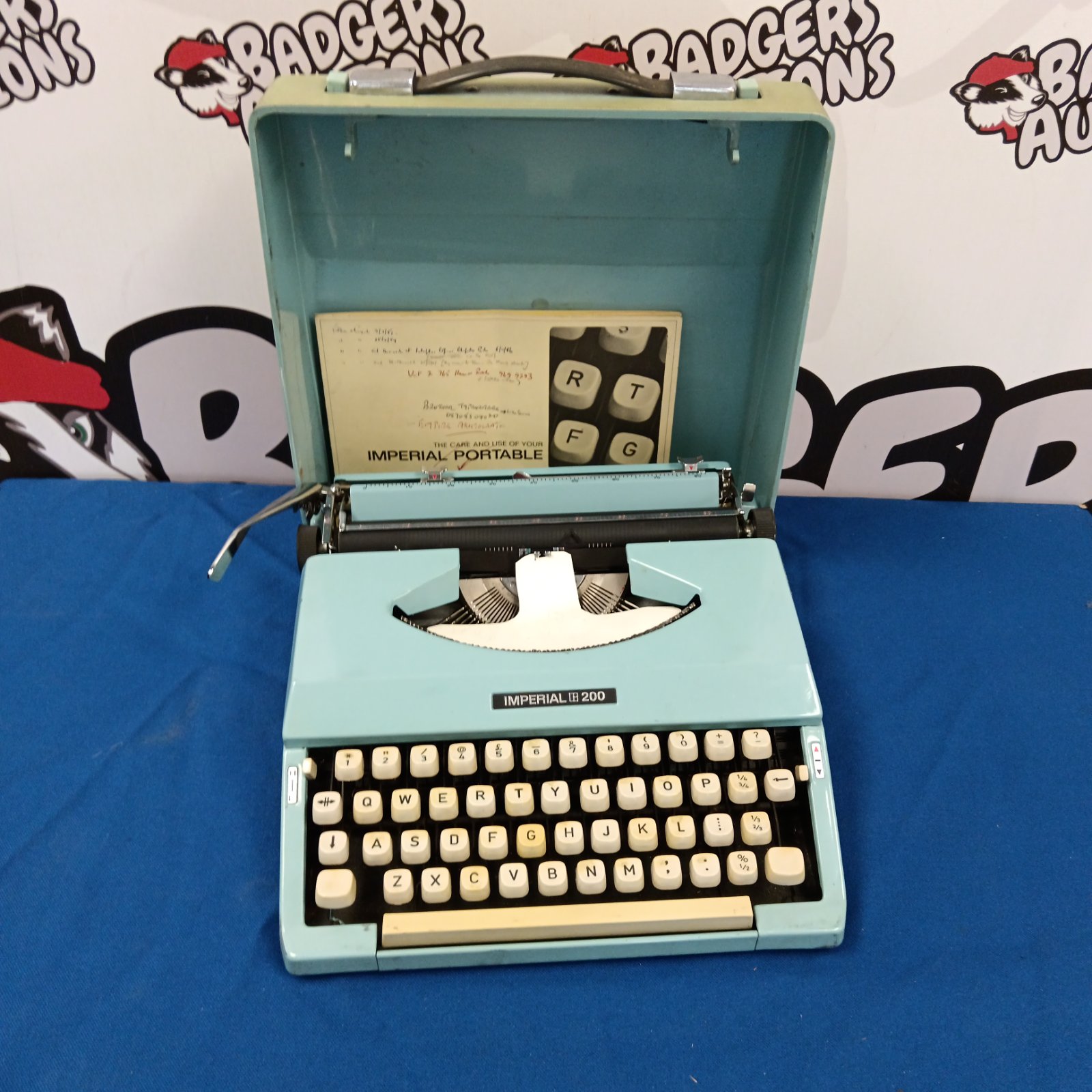 Vintage Imperial 200 typewriter in blue with open case.