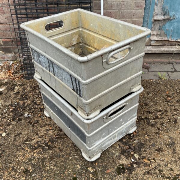 Stack of two vintage industrial metal storage crates.