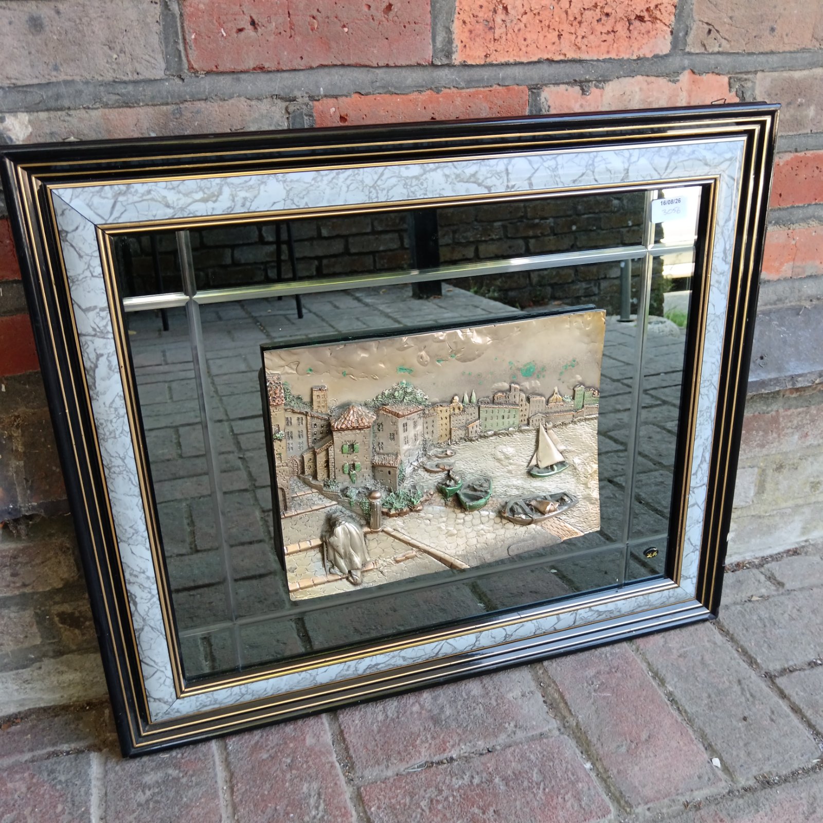 Vintage Italian silver relief mirror with coastal village scene.