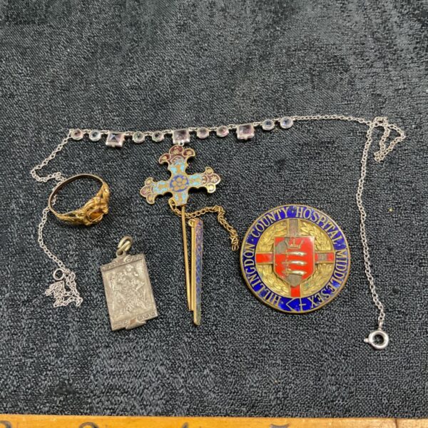 Vintage costume jewellery lot with hospital badge and sword pendant.