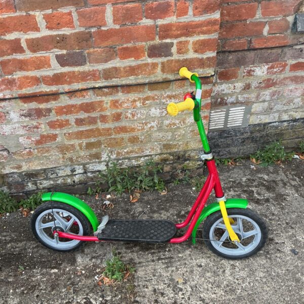 Vintage Kettler kick scooter with red frame and green handlebars.