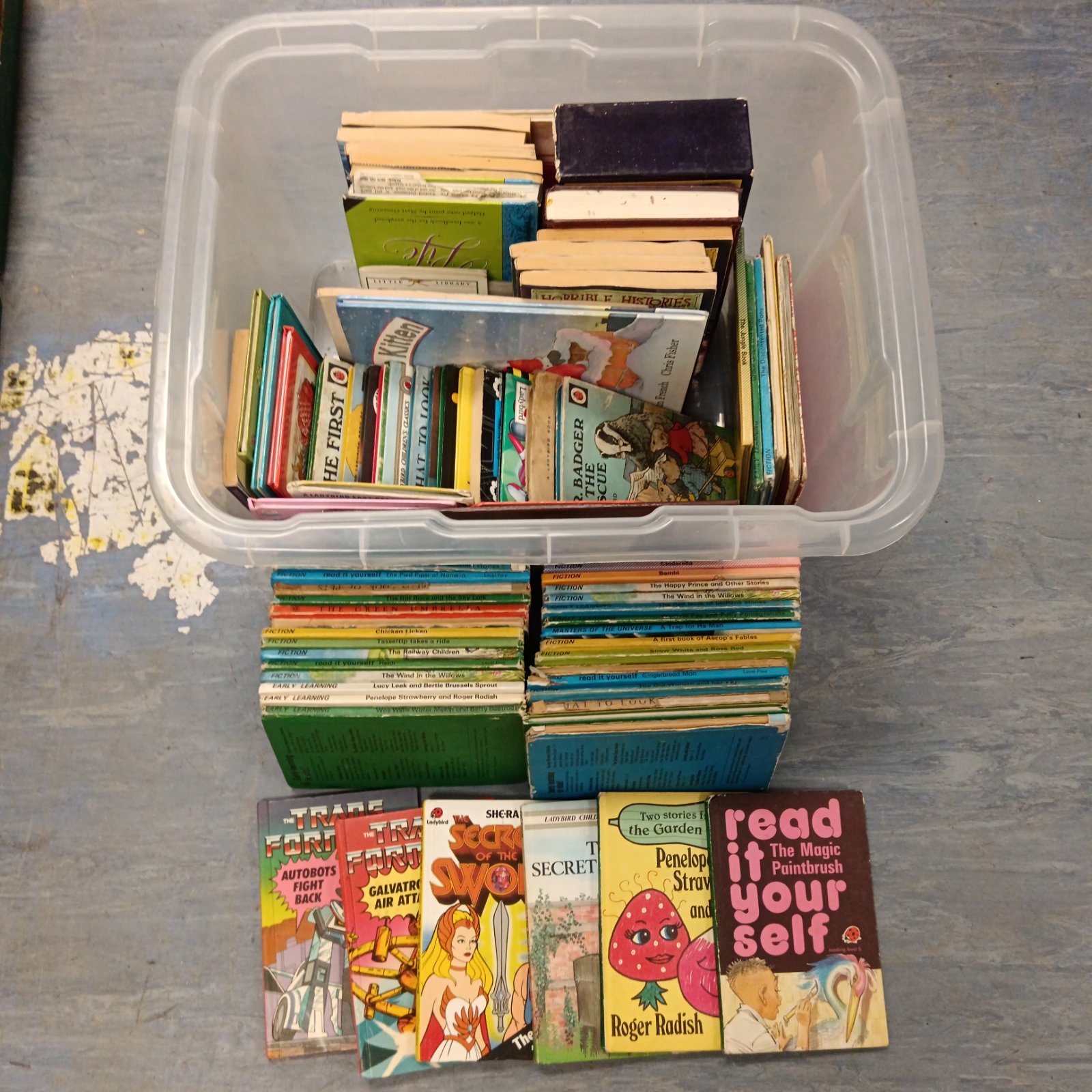 Vintage Ladybird books collection featuring Transformers and He-Man.
