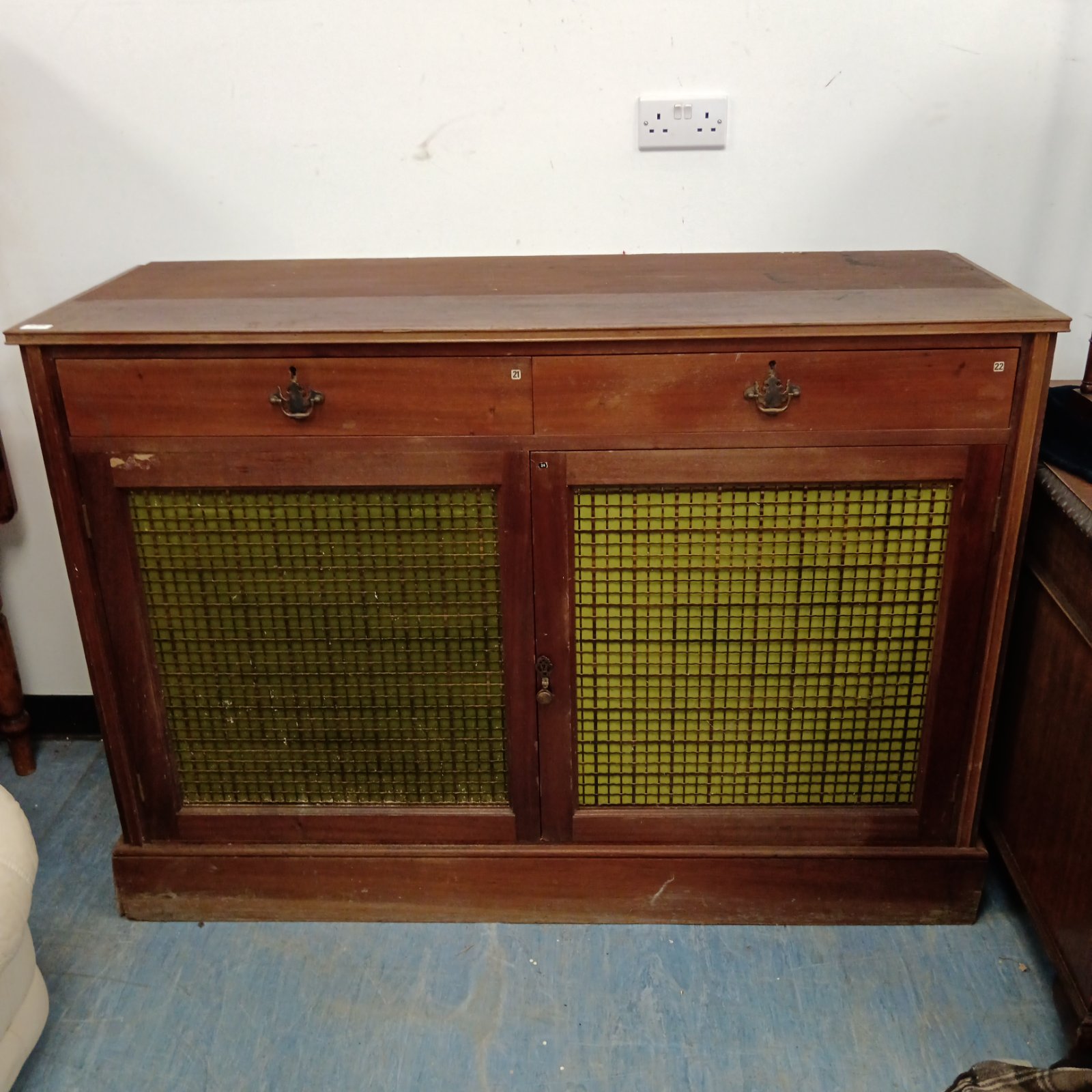 Vintage larder cabinet with metal grill fronts for kitchen storage.