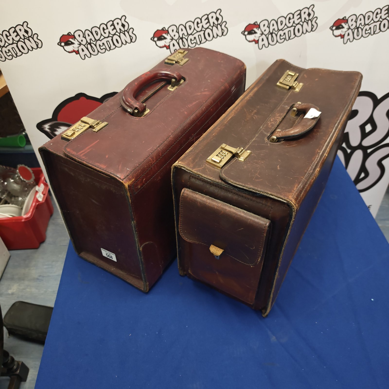 Pair of vintage brown leather briefcases with locks.