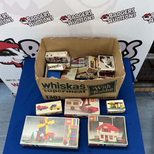 Box of vintage Lego System LegoLand sets with various boxes visible.