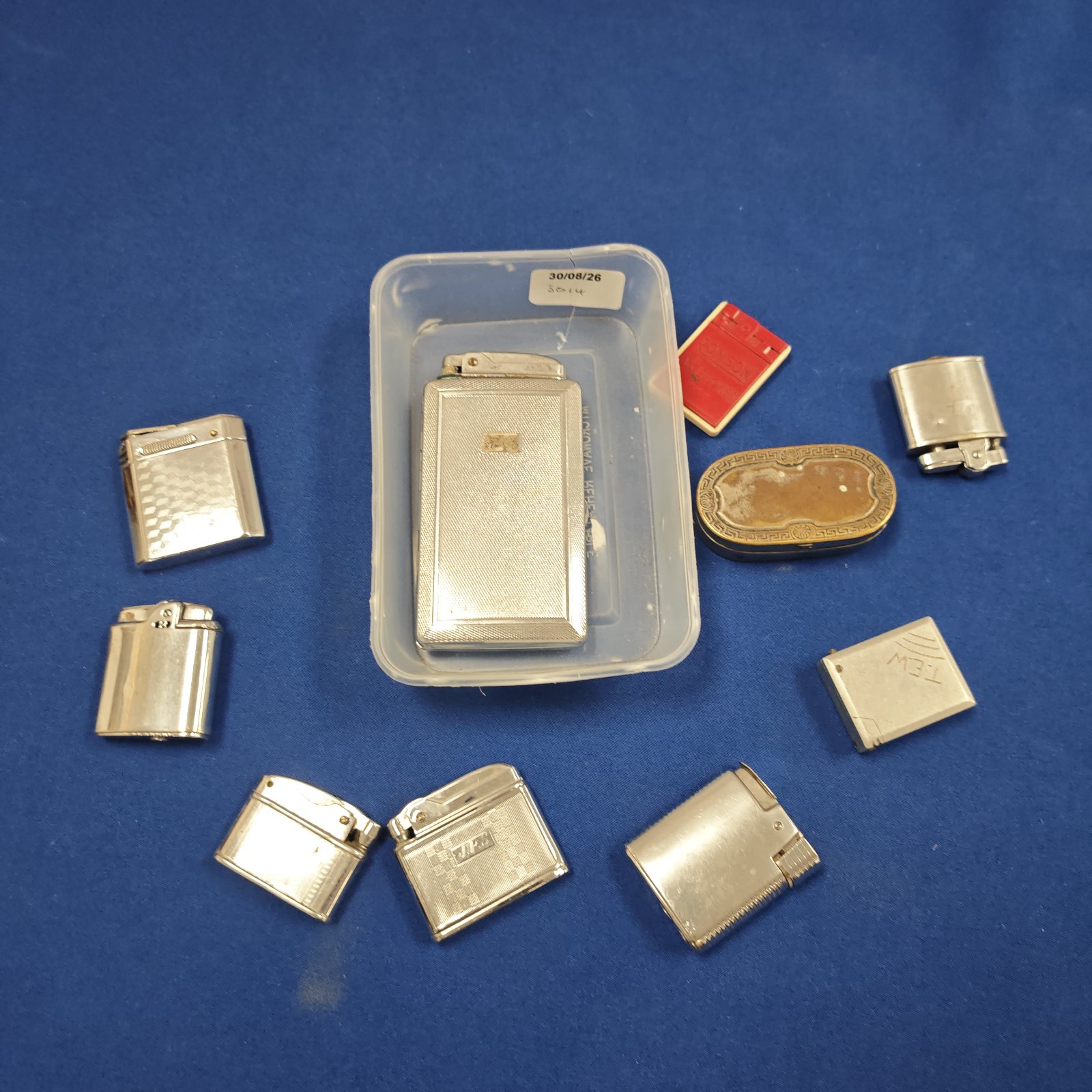 Vintage lighters in a tub, collectible metal gas lighters.