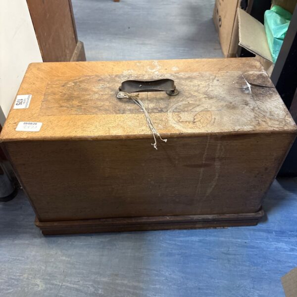 Vintage locked sewing machine in wooden cabinet, antique collectible.