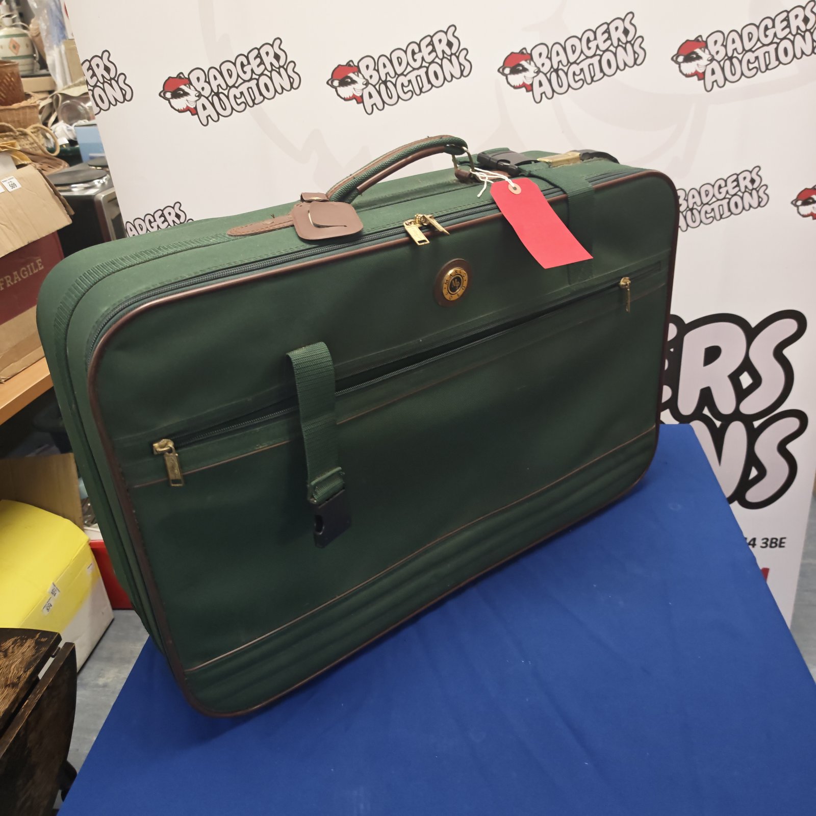 Vintage green Marco Polo suitcase, classic retro travel luggage.