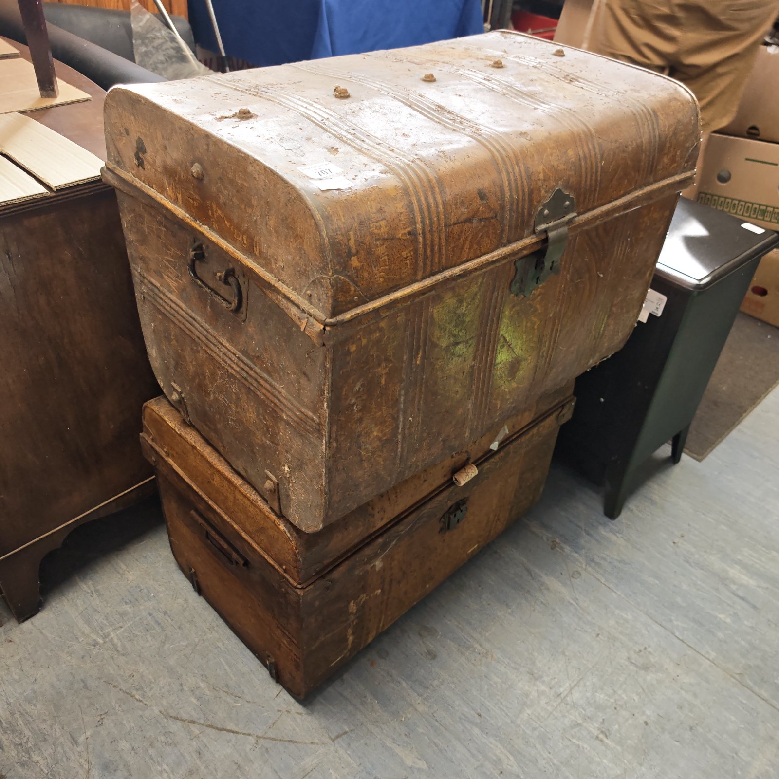 Stacked vintage metal chests with aged patina.