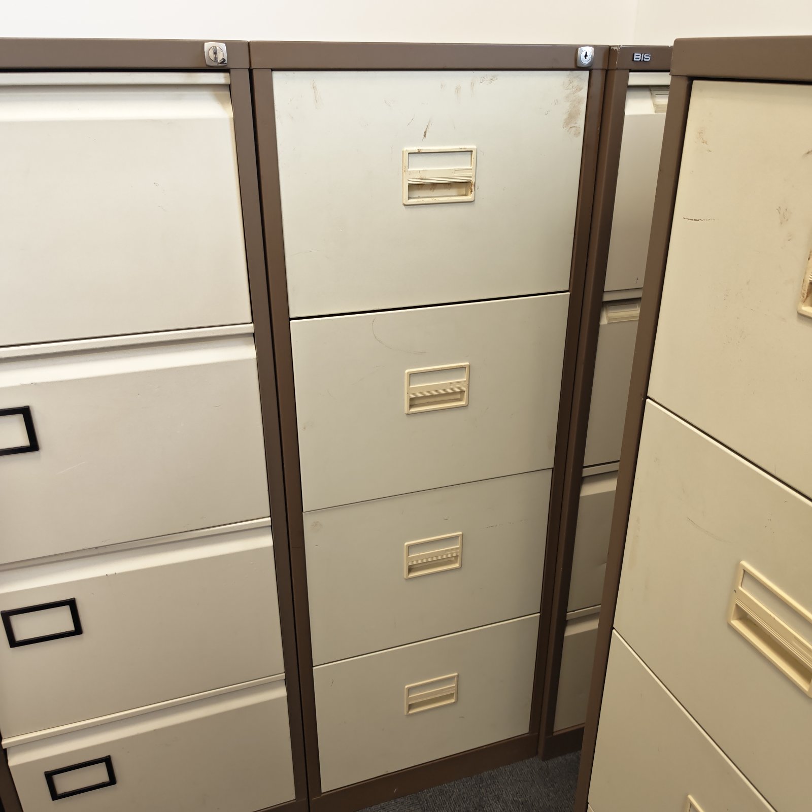 Vintage four-drawer metal filing cabinet for office document storage.
