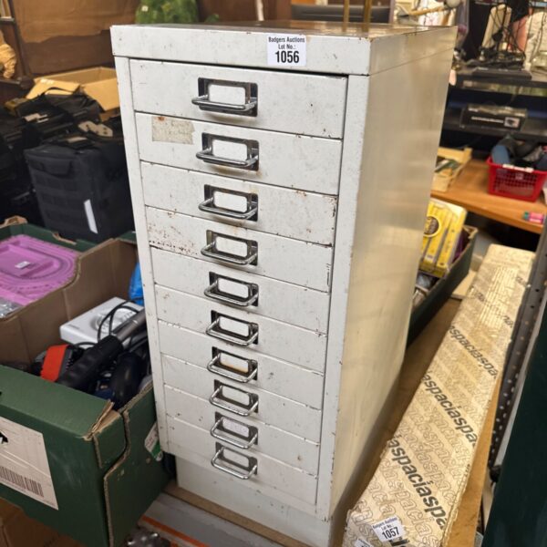 Vintage metal filing cabinet with multiple drawers for office storage.