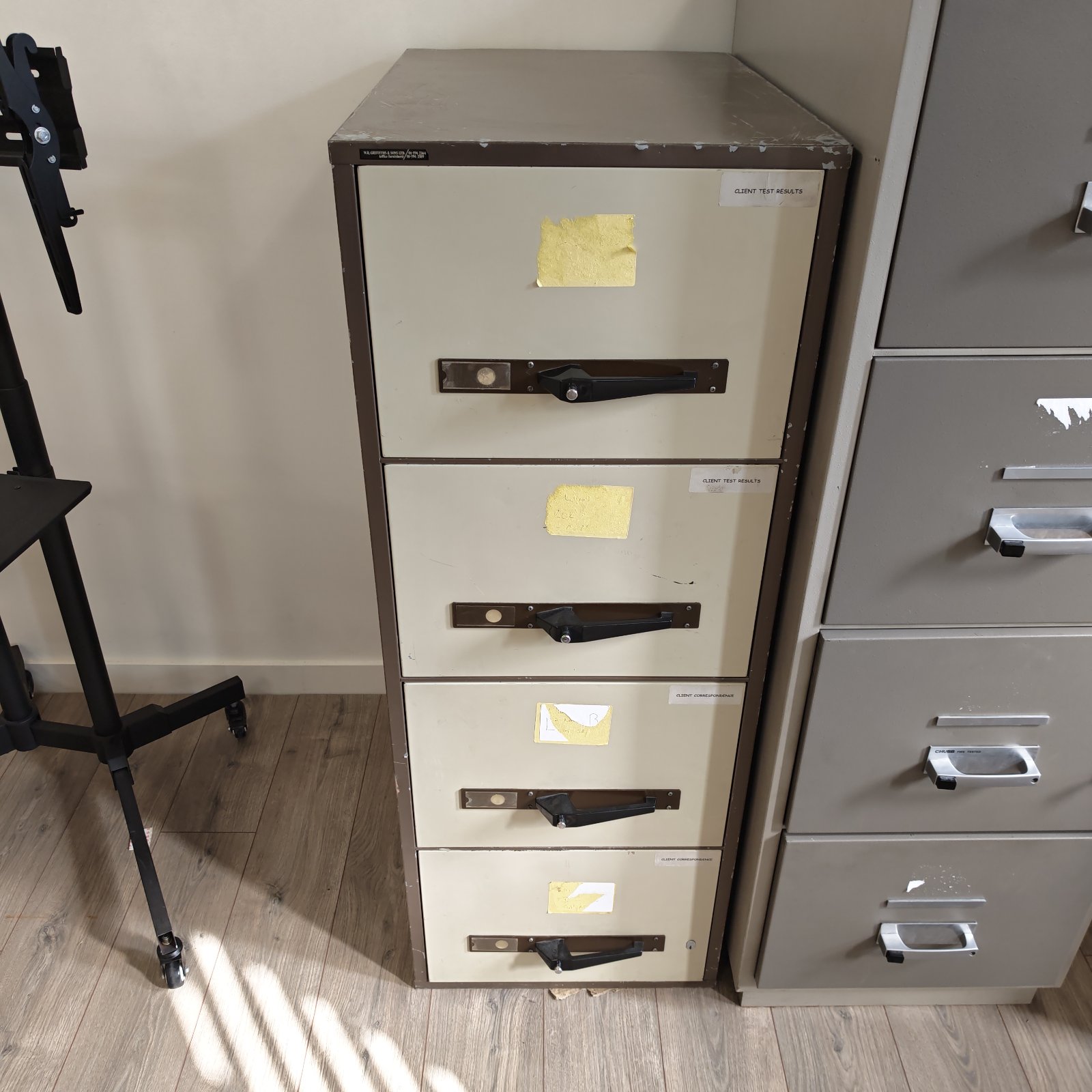 Vintage metal filing cabinet with four drawers, ideal for office storage.