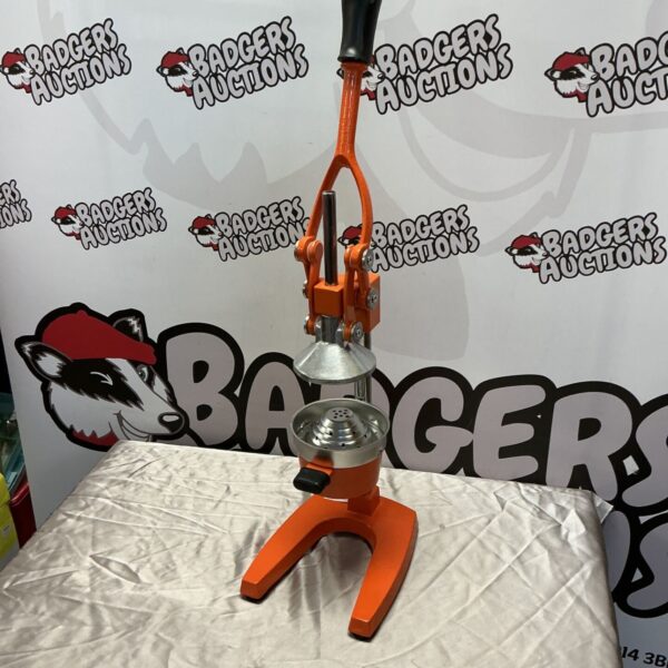 Vintage metal citrus juicer with red enamel finish.