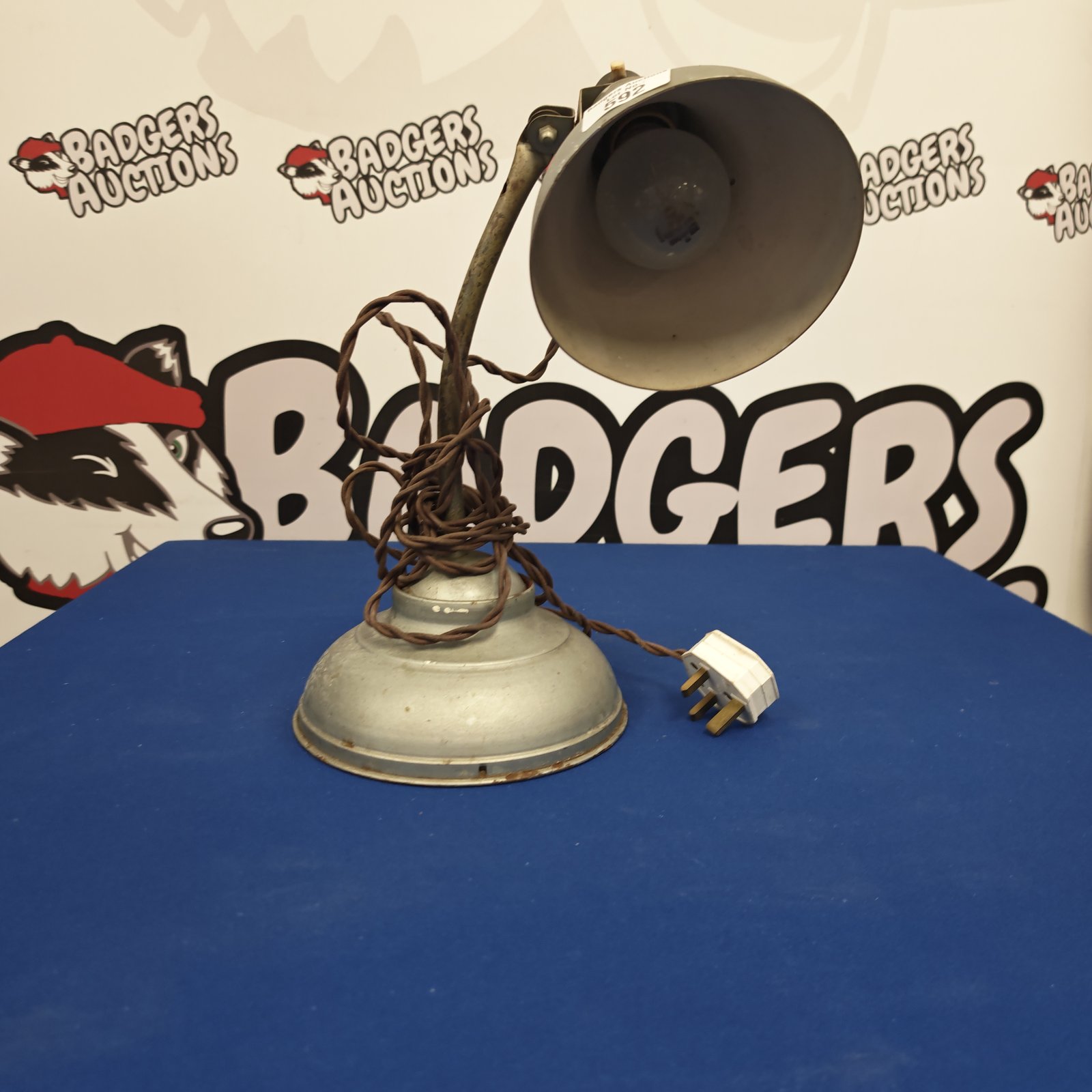 Vintage metal table lamp with adjustable arm and shade.
