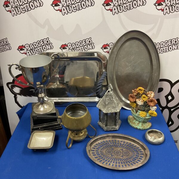 Vintage metalware lot featuring serving trays and a cast iron doorstop.