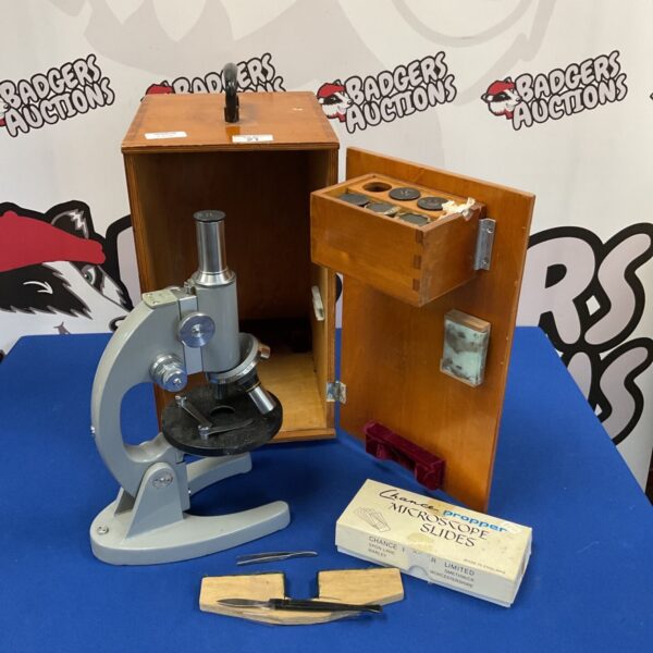 Vintage Wuchow microscope set with wooden case and slides.