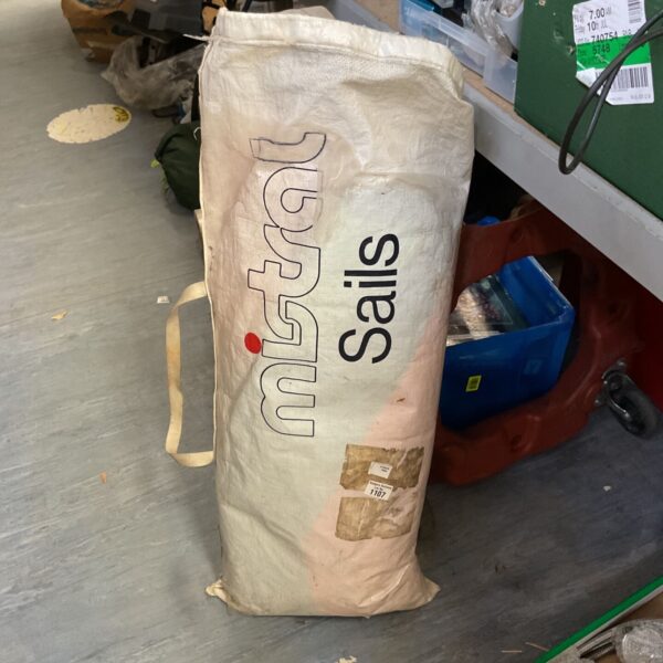 Vintage Mistral sail folded, showing sailcloth and classic design.